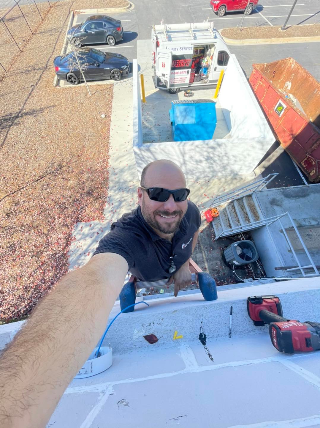 Nick Tinsley, Owner and principal engineer at NT Security reaching new heights during rooftop installation of security cameras