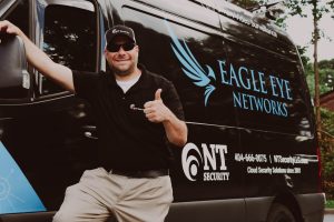Nick Tinsley, Owner of NT Security giving a thumbs up from his Atlanta service vehicle
