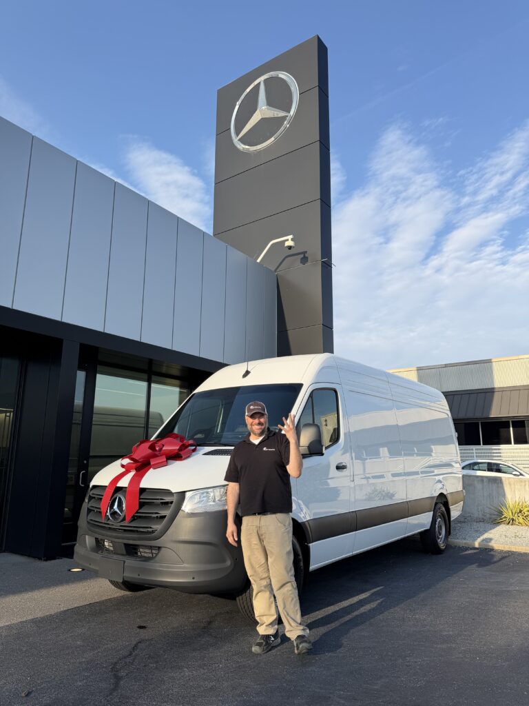 Nick Tinsley celebrating 25 years in security with a new van.