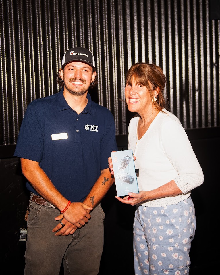 Second JBL Flip 6 speaker giveaway winner posing with Vinny Orlando of NT Security at the Atlanta Family Movie Night